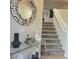 Elegant staircase with a glass-top console table and decor at 7914 Torreys Peak St, Las Vegas, NV 89166