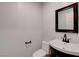 Simple bathroom with dark vanity and framed mirror at 8214 Mt Brodie Cir, Las Vegas, NV 89145