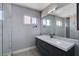 Modern bathroom with single sink, large mirror and walk-in shower at 8214 Mt Brodie Cir, Las Vegas, NV 89145