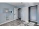 Light blue bedroom with wood-look flooring, mirror, and closet at 8214 Mt Brodie Cir, Las Vegas, NV 89145