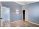 Comfortable bedroom with light blue walls and wood-look floors at 8214 Mt Brodie Cir, Las Vegas, NV 89145