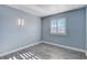 Light blue bedroom with wood-look flooring, window with shutters, and closet at 8214 Mt Brodie Cir, Las Vegas, NV 89145