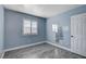 Light blue bedroom with wood-look flooring, window with shutters, and closet at 8214 Mt Brodie Cir, Las Vegas, NV 89145