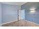 Spacious bedroom with light blue walls, wood-look floors, and access to another room at 8214 Mt Brodie Cir, Las Vegas, NV 89145