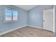 Charming bedroom with light blue walls, wood-look floors, and window shutters at 8214 Mt Brodie Cir, Las Vegas, NV 89145