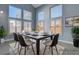 Bright dining room with large windows and a spacious table, virtually staged at 8214 Mt Brodie Cir, Las Vegas, NV 89145