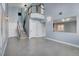 Two-story entryway with gray tile floors and a wooden staircase at 8214 Mt Brodie Cir, Las Vegas, NV 89145