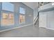 Light and airy living room with gray tile floors and staircase at 8214 Mt Brodie Cir, Las Vegas, NV 89145