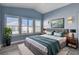 Virtually staged main bedroom with gray flooring and lots of natural light at 8214 Mt Brodie Cir, Las Vegas, NV 89145