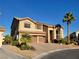 Two-story house with a three-car garage and solar panels at 9012 Alpine Peaks Ave, Las Vegas, NV 89147