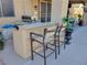 Outdoor kitchen with granite countertop and seating for two at 9012 Alpine Peaks Ave, Las Vegas, NV 89147