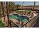 Large kidney shaped pool with spa and multiple lounge chairs at 9012 Alpine Peaks Ave, Las Vegas, NV 89147