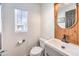 Stylish bathroom with a wood-paneled accent wall and modern vanity at 9157 Chenille Ct, Las Vegas, NV 89149