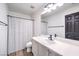 Bathroom with vanity, sink, shower, and white tiled floor at 9157 Chenille Ct, Las Vegas, NV 89149