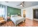 Spacious bedroom with wood floors, green accent wall, and ceiling fan at 9157 Chenille Ct, Las Vegas, NV 89149