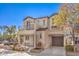 Two-story house with balcony, two-car garage, and landscaped yard at 9157 Chenille Ct, Las Vegas, NV 89149