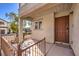 Small front porch with brown door and wrought iron railing at 9157 Chenille Ct, Las Vegas, NV 89149