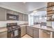 Well-equipped kitchen featuring gray cabinets and a gas stove at 9157 Chenille Ct, Las Vegas, NV 89149