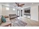 Living room with tiled floor, couches, and a large TV at 9157 Chenille Ct, Las Vegas, NV 89149