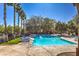 Community pool with lounge chairs and palm trees at 9157 Chenille Ct, Las Vegas, NV 89149