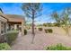 Landscaped backyard with gravel and covered patio at 9452 Gold Mountain Dr, Las Vegas, NV 89134