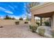 Desert landscaping with gravel and a covered patio at 9452 Gold Mountain Dr, Las Vegas, NV 89134