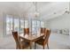 Bright dining room with wood table and chairs, and view into living room at 9452 Gold Mountain Dr, Las Vegas, NV 89134