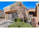 Tan one-story house with a brown door and two-car garage at 9452 Gold Mountain Dr, Las Vegas, NV 89134