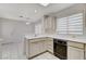 Kitchen with white cabinets, black appliances, and tiled floor at 9452 Gold Mountain Dr, Las Vegas, NV 89134