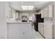 Kitchen with white cabinets, black appliances, and breakfast bar at 9452 Gold Mountain Dr, Las Vegas, NV 89134