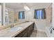 Modern bathroom with double sinks, tile flooring, and a large mirror at 9753 Russian Hill St, Las Vegas, NV 89141