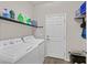 Laundry room with washer, dryer, and extra shelving at 9753 Russian Hill St, Las Vegas, NV 89141