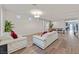 Open living room with white leather couches and large windows at 9753 Russian Hill St, Las Vegas, NV 89141