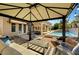 Backyard gazebo with seating area, next to pool with a waterfall feature and nearby outdoor seating at 2111 Bogart Ct, Las Vegas, NV 89117