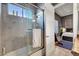 Bathroom featuring a marble tiled shower with glass doors and a view into the bedroom at 2111 Bogart Ct, Las Vegas, NV 89117