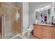Well-lit bathroom features a glass shower and classic vanity with granite counters at 2111 Bogart Ct, Las Vegas, NV 89117