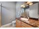 Bathroom with a marble countertop vanity, a large mirror and modern lighting fixture at 2111 Bogart Ct, Las Vegas, NV 89117