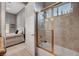 Bathroom with marble tiled shower and a view into the gray painted bedroom at 2111 Bogart Ct, Las Vegas, NV 89117