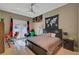 Bedroom features a ceiling fan, outdoor access, natural light, and neutral tones at 2111 Bogart Ct, Las Vegas, NV 89117
