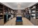Spacious walk-in closet with custom shelving, storage, hardwood floors, and a central tufted bench at 2111 Bogart Ct, Las Vegas, NV 89117