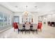Formal dining room with chandelier, stone archways, and seating for eight people with ample space at 2111 Bogart Ct, Las Vegas, NV 89117