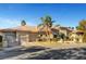 Daytime view of home's exterior showcasing a tile roof, multiple garages, and manicured landscaping at 2111 Bogart Ct, Las Vegas, NV 89117