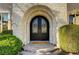 Close-up of the arched front door showing the welcome mat and decorative glass detail at 2111 Bogart Ct, Las Vegas, NV 89117