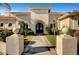 Stately walkway leading to a beautifully arched stone front door at 2111 Bogart Ct, Las Vegas, NV 89117