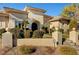 Elegant front exterior with detailed stonework, arched entry and mature landscaping at 2111 Bogart Ct, Las Vegas, NV 89117