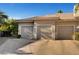 Three car garage with concrete driveway and light colored doors and trim at 2111 Bogart Ct, Las Vegas, NV 89117