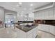 Gourmet kitchen featuring white cabinetry, marble countertops, a center island and luxury appliances at 2111 Bogart Ct, Las Vegas, NV 89117