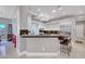 Modern kitchen with white cabinetry, breakfast bar with seating, and marble countertops at 2111 Bogart Ct, Las Vegas, NV 89117