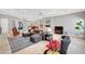 Open living room with neutral paint and tile flooring, flowing into the dining and kitchen areas at 2111 Bogart Ct, Las Vegas, NV 89117