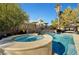 Backyard pool and spa featuring a unique tiled waterfall accent wall, with gazebo and seating area at 2111 Bogart Ct, Las Vegas, NV 89117